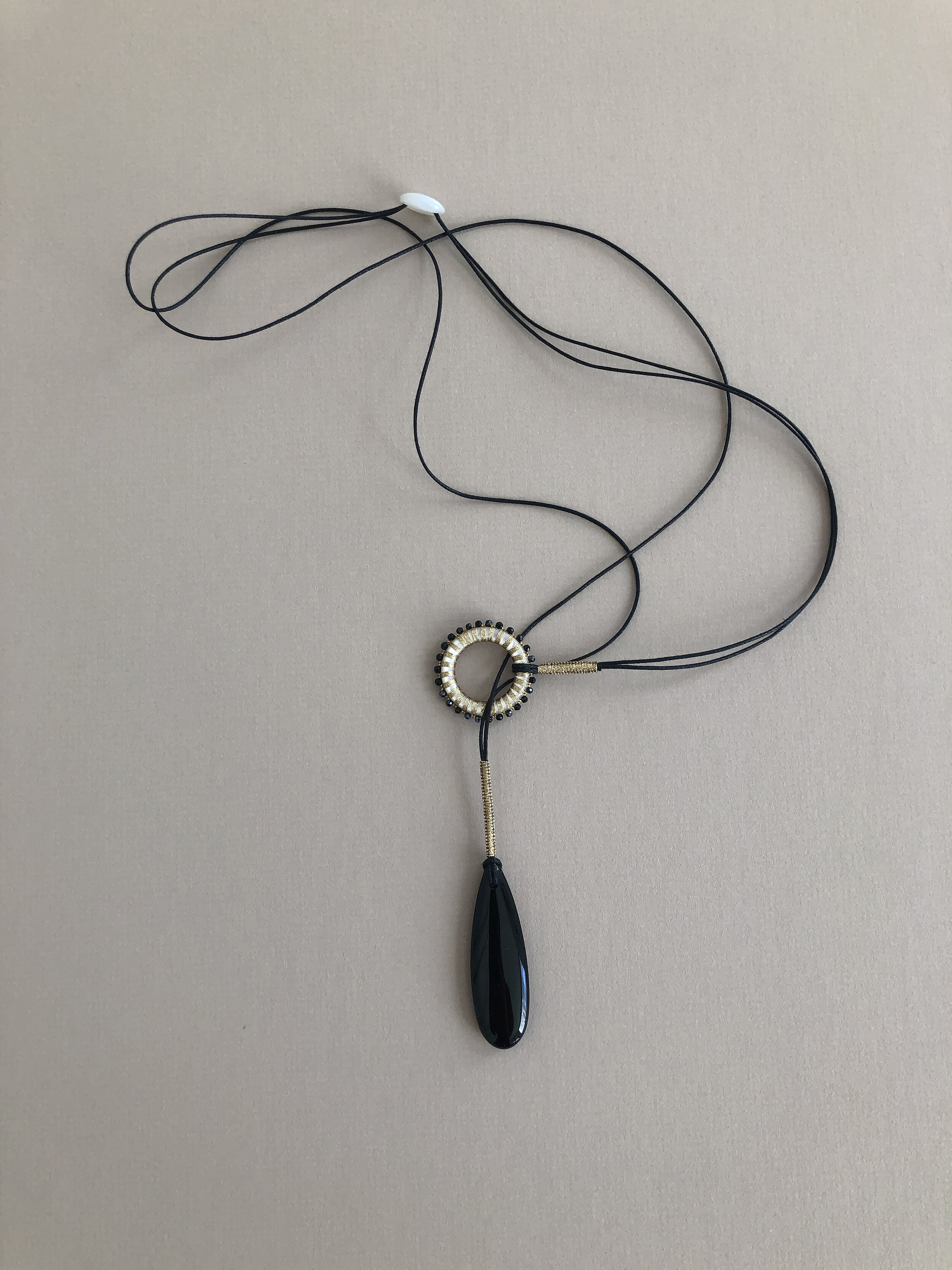 NJY107 BLACK AGATE DROP LARIAT WITH 25MM SOUTH SEA MOTHER OF PEARL  (PINCTADAD MAXIMA AUSTRALIA) HAND WOVEN WITH BLACK SPINEL — SIMON ALCANTARA  LLC