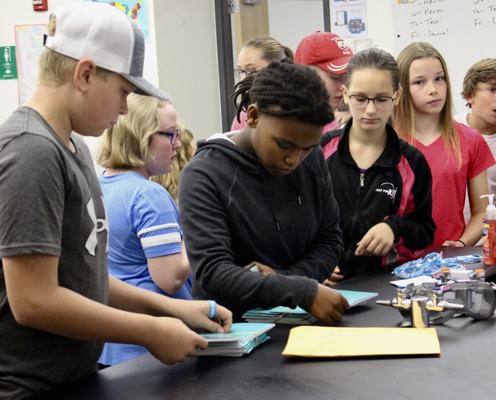 Students pick up a booklet filled with issues affecting youth and how to get help.