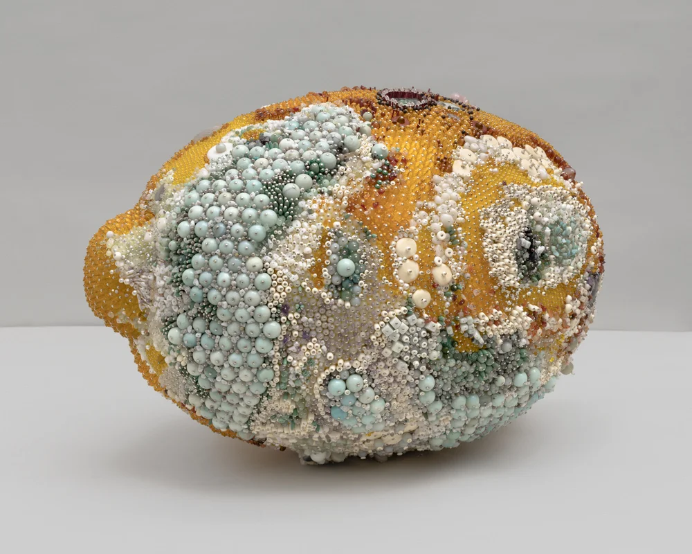 “Bad Lemon (Creep)” (2019), amazonite, aventurine, black onyx, Italian onyx, turquoise, labradorite, carnelian, ocean jasper, sesame jasper, serpentine, fluorite, Ching Hai jade, snow quartz, magnesite, agate, breccicated jasper, rhodonite, rhodochrosite, red agate, garnet, tree agate, rose quartz, amethyst, lilac stone, limestone, marble, mother of pearl, bone, freshwater pearl, glass, steel pins on coated polystyrene, 20 x 20 x 28 1/2 inches