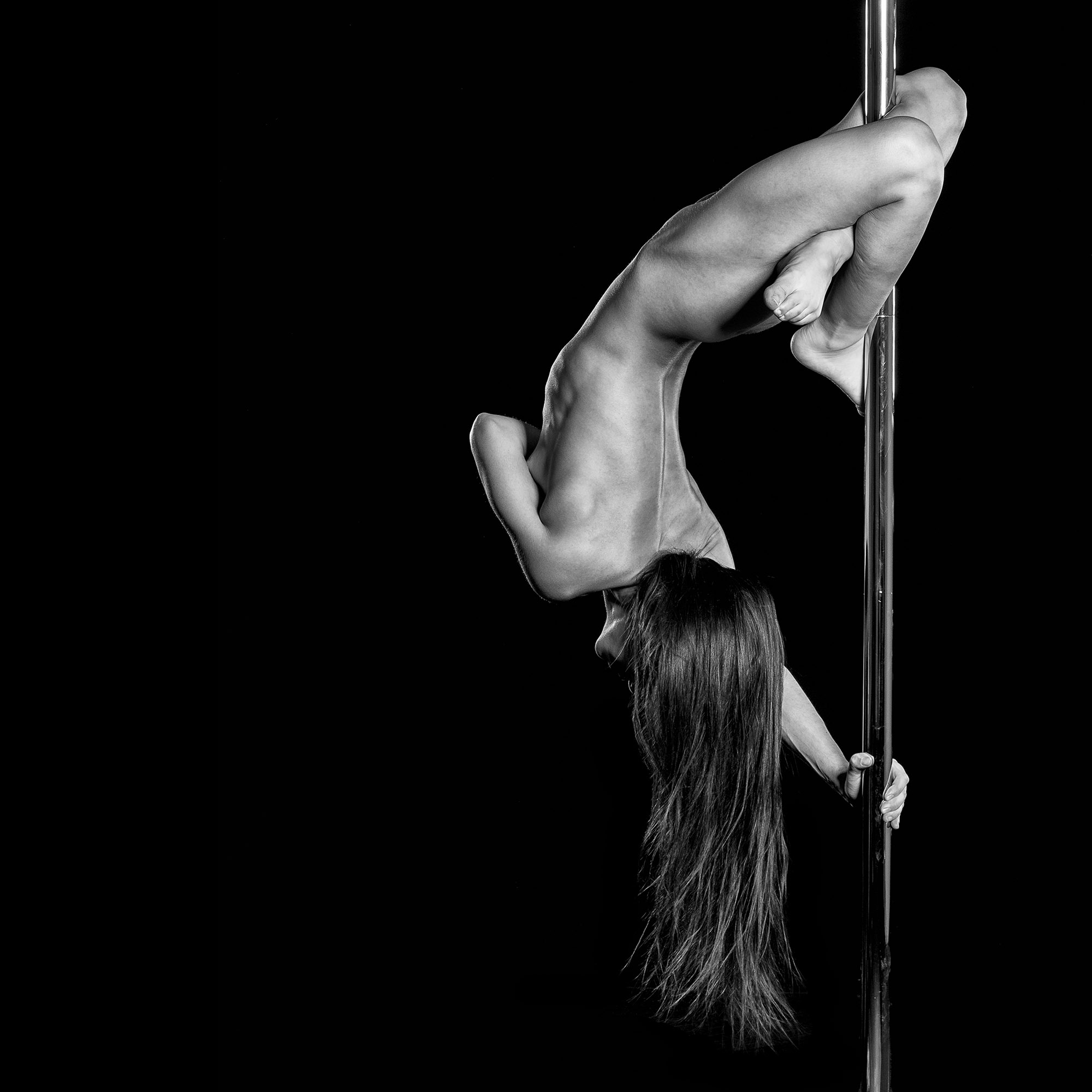 Naked female pole dancer