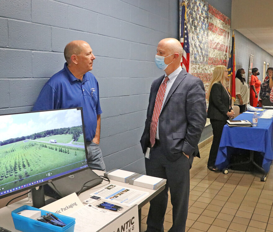 Columbus County Manager Eddie Madden talks with a representative from Atlantic Packaging.