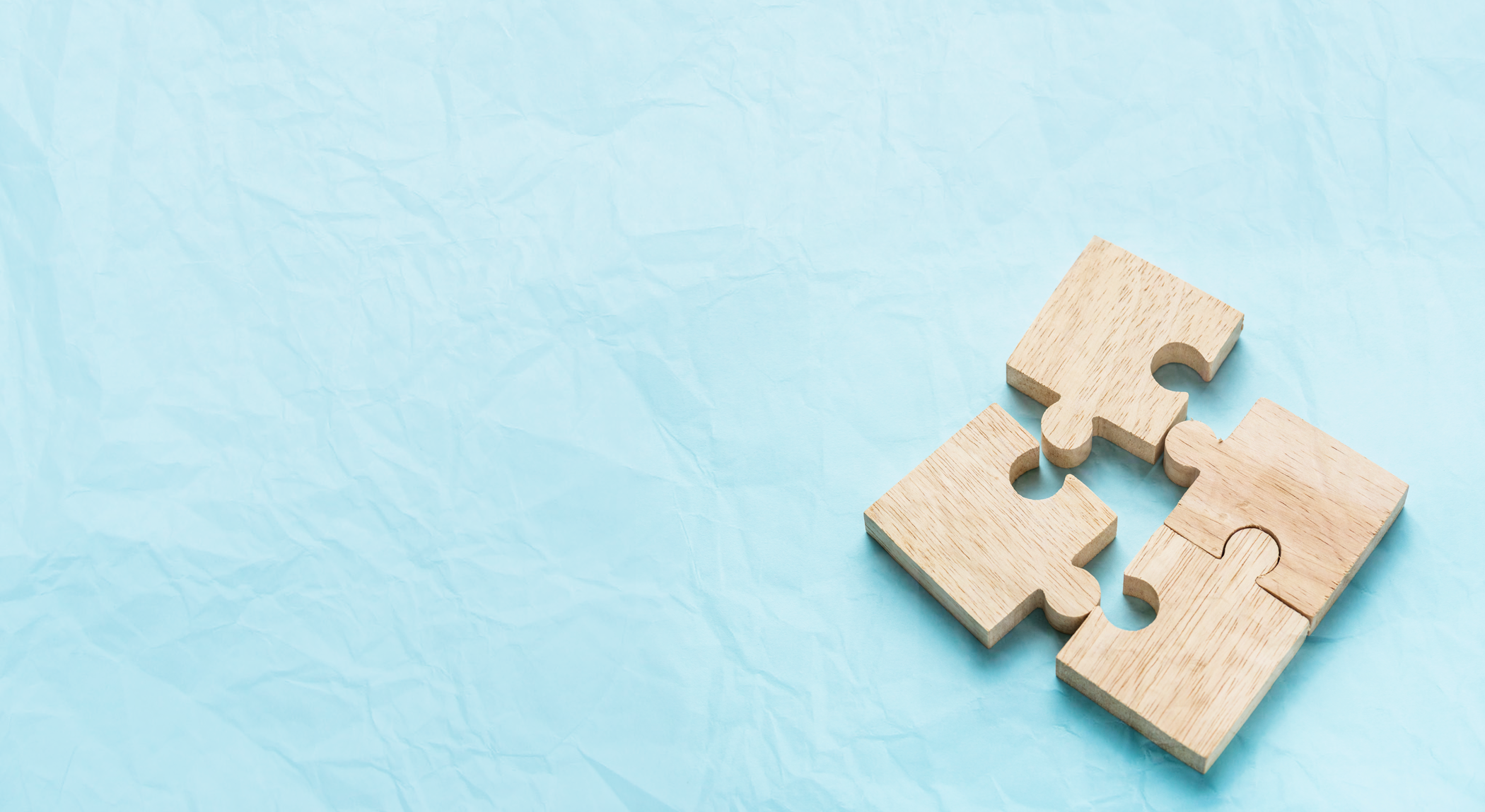 Puzzle-pieces_paper-blue-background.png
