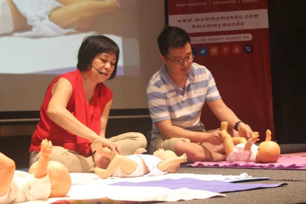 A dad learns how to massage a baby