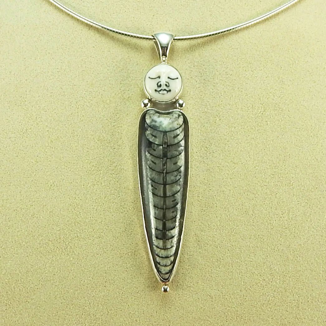 127: Fossil & Carved Bone Face Pendant — Silver Stone