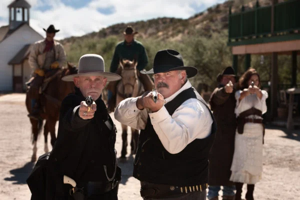 Brave men aim their guns in old west town