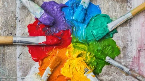 Brushes and oil paint, messy spectrum of colours