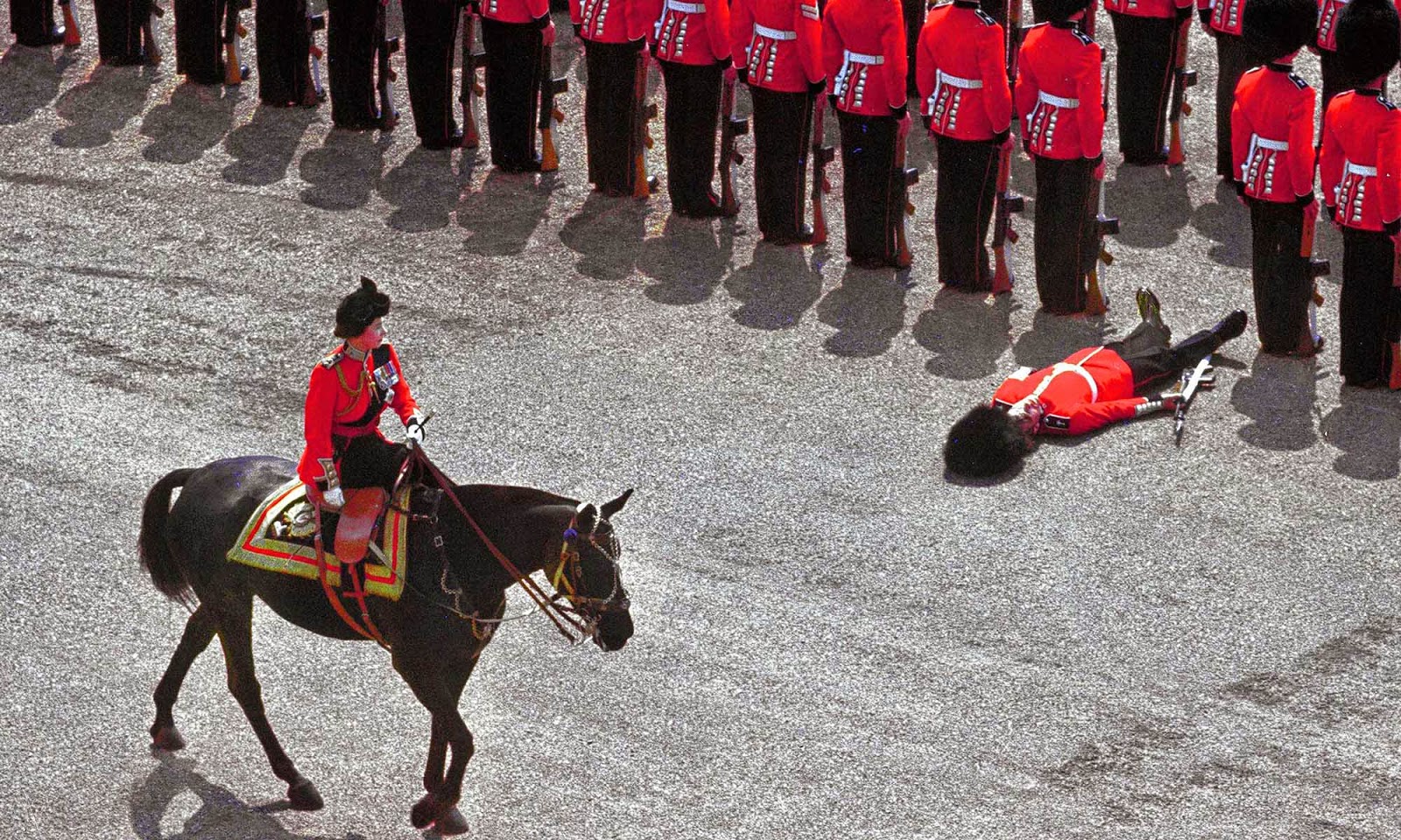 a_guard_of_honor_passes_out_as_queen_elizabeth_ii_rides_past_ding_the_thoping_the_color_parade,_1970.jpg.
