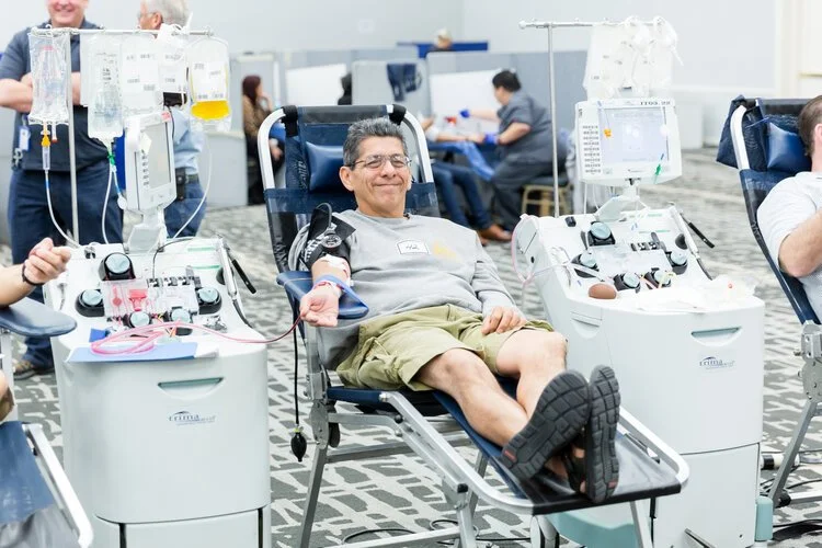 Person giving blood in a reclined chair