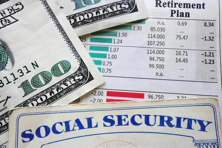Social Security card, money and a retirement plan stacked