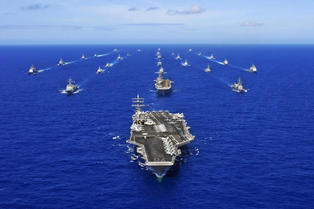 The aircraft carrier USS Ronald Reagan transits the Pacific Ocean with ships assigned to Rim of the Pacific 2010 combined task force as part of a photo exercise north of Hawaii. RIMPAC, the worldÂ’s largest multinational maritime exercise is a biennial event which allows participating nations to work together to build trust and enhance partnerships needed to improve maritime security. (U.S. Navy photo by Mass Communication Specialist 3rd Class Dylan McCord/RELEASED)