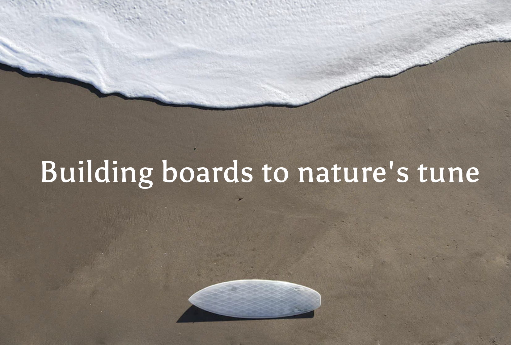 Building boards to nature's tune. White sea foam on the coast above the text. Below the text is a swellcycle surfboard laying on the sand on it's side.
