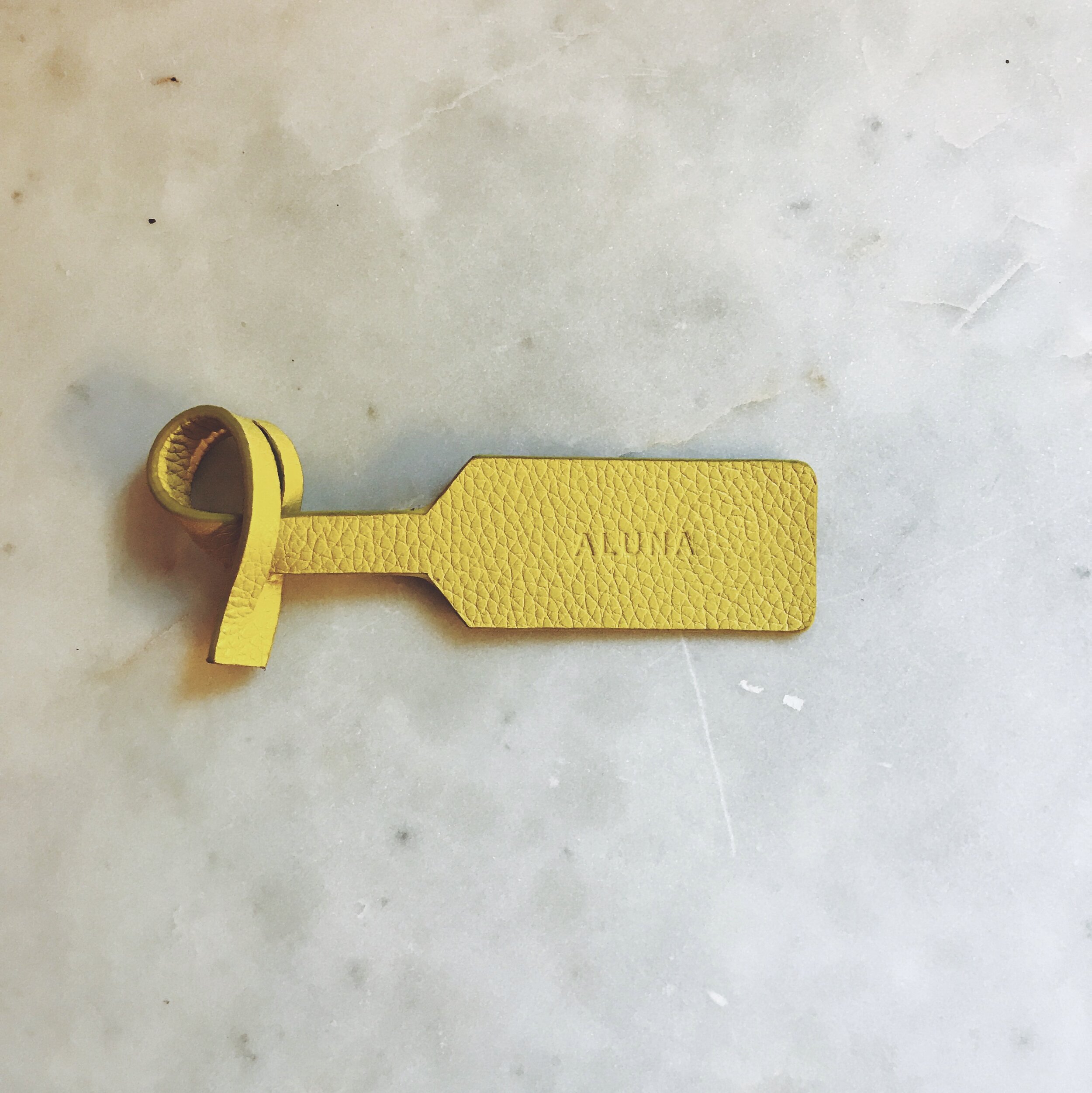 yellow luggage tag