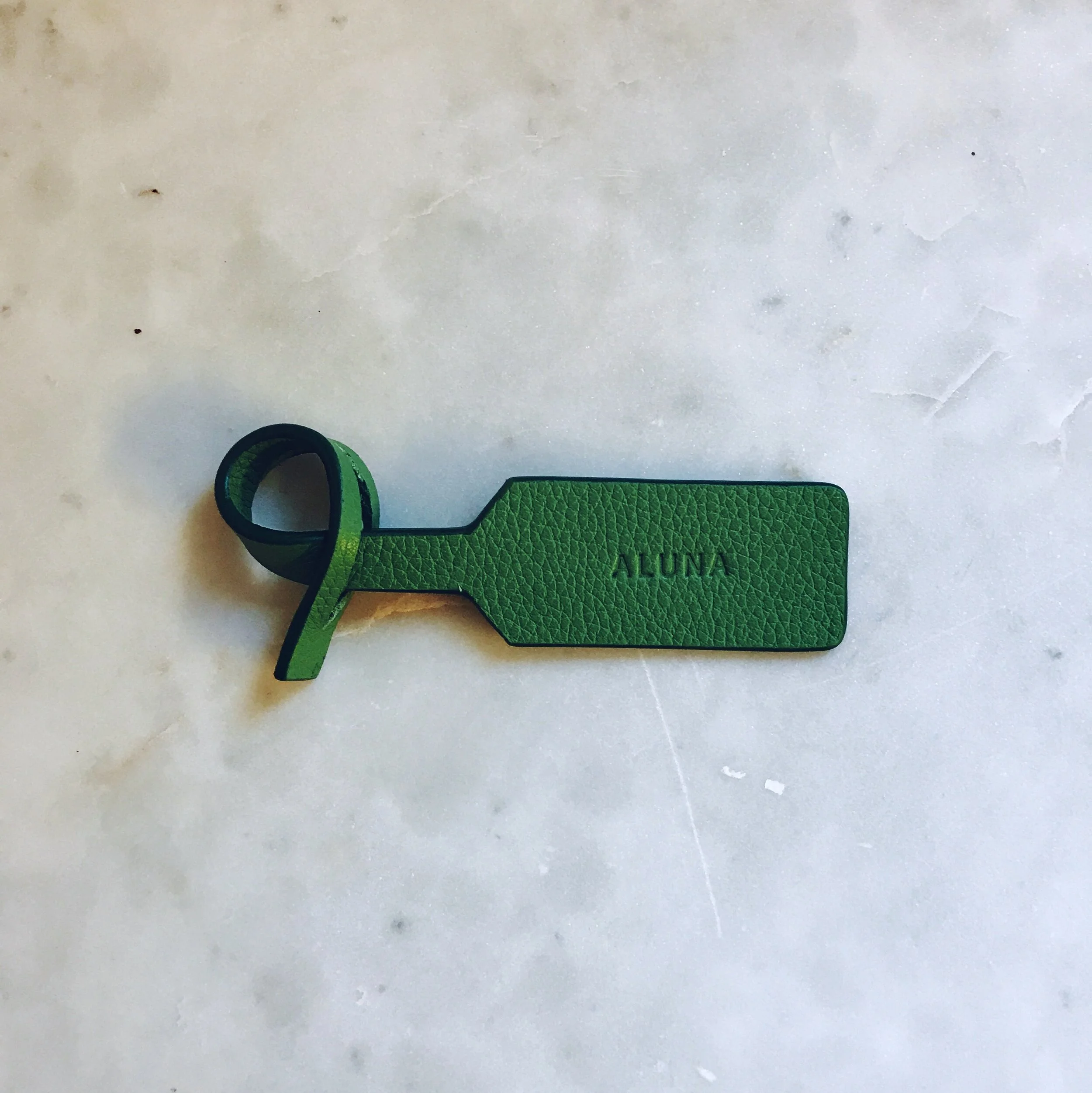green luggage tags