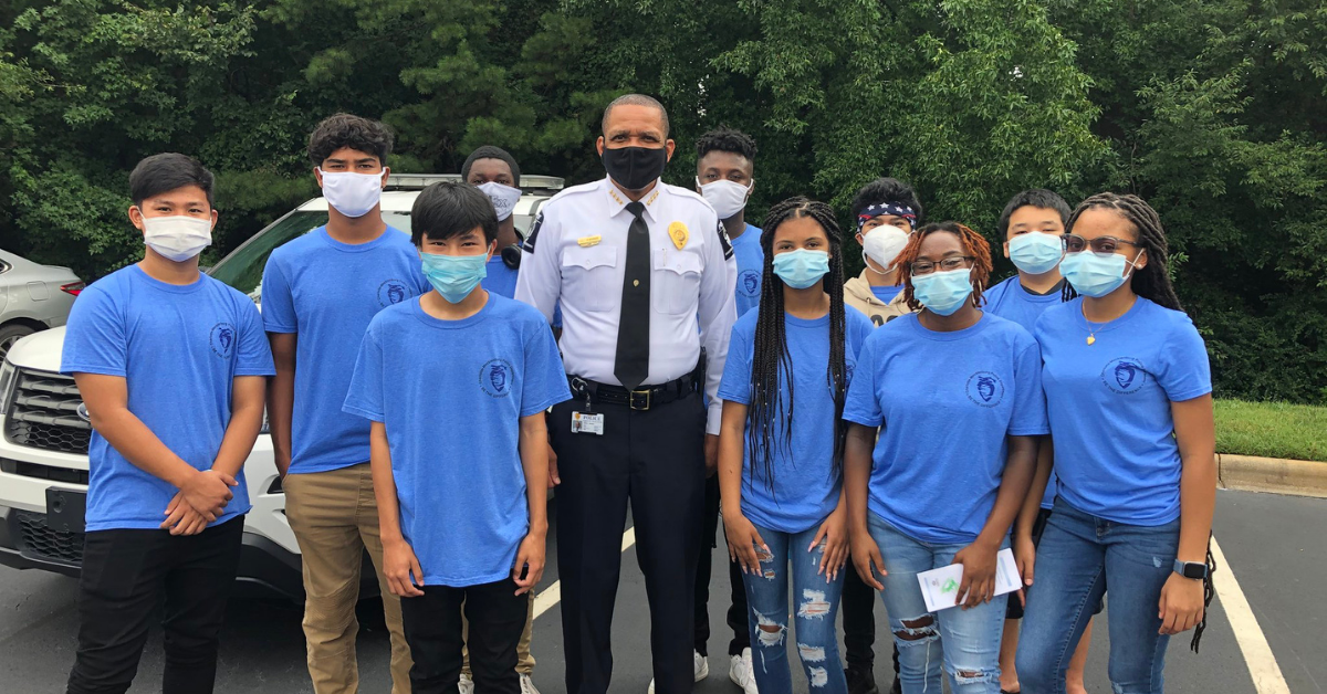 CMPD Chief Johnny Jennings and REACH Program Participants.png