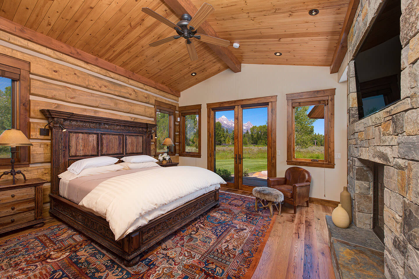 Bedroom with king bed and native stone fireplace