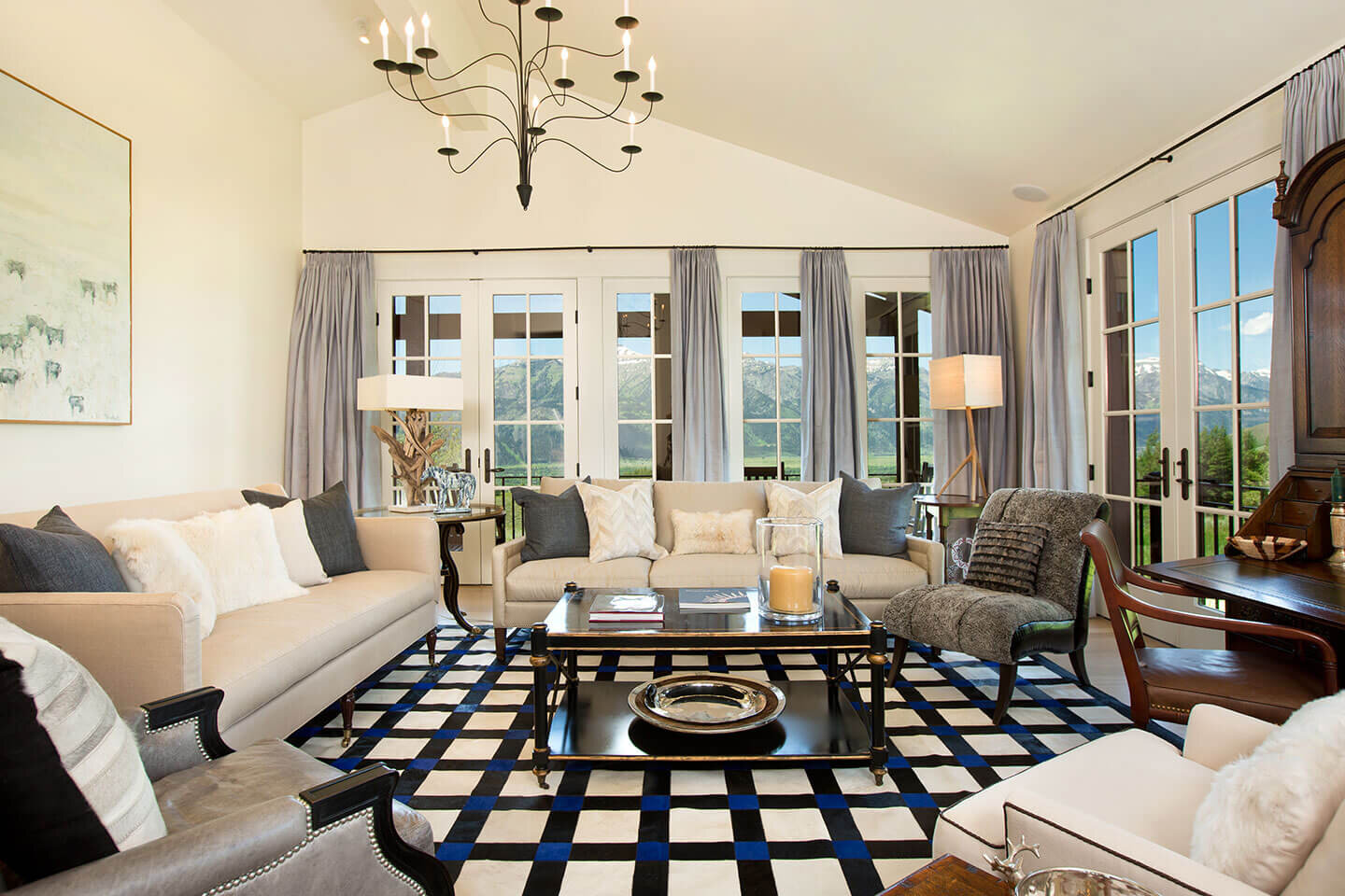 Living room with geometric pattern rug and chandelier