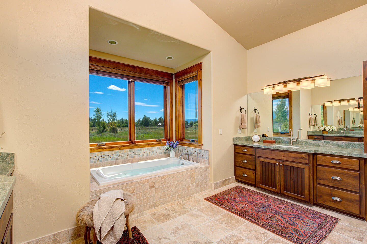 Bathroom with travertine stone and view