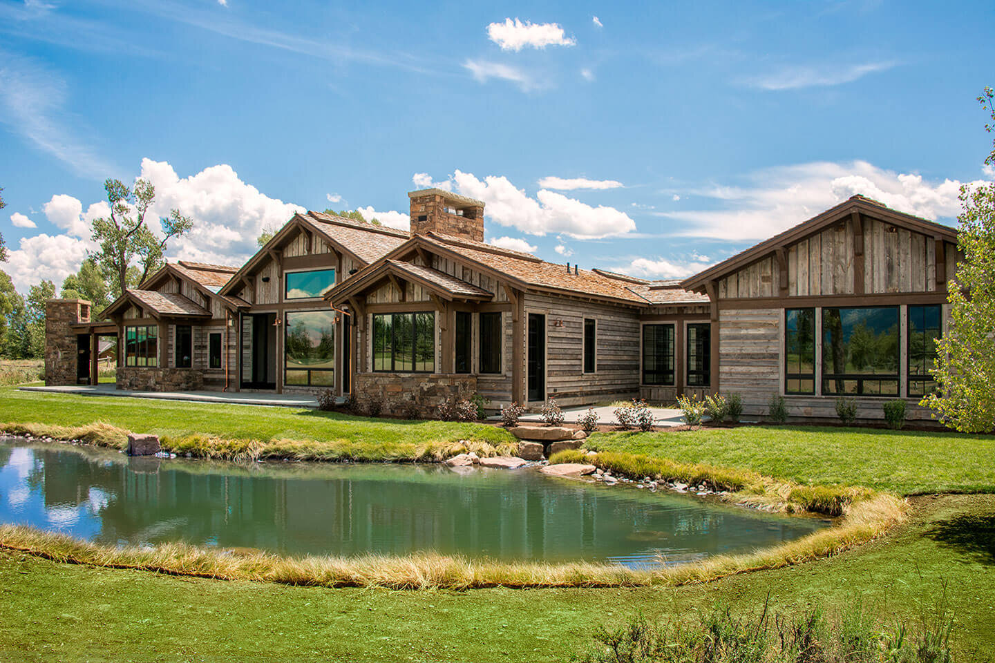 Reclaimed wood home facade and pond