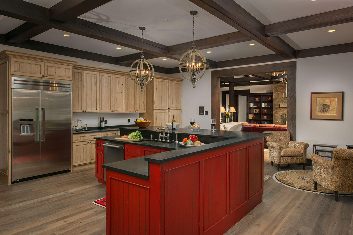 Red center counter in kitchen with spherical chandeliers