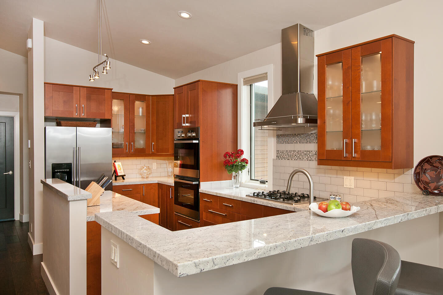 Kitchen with marble counter tops and cherry wood cabinetry