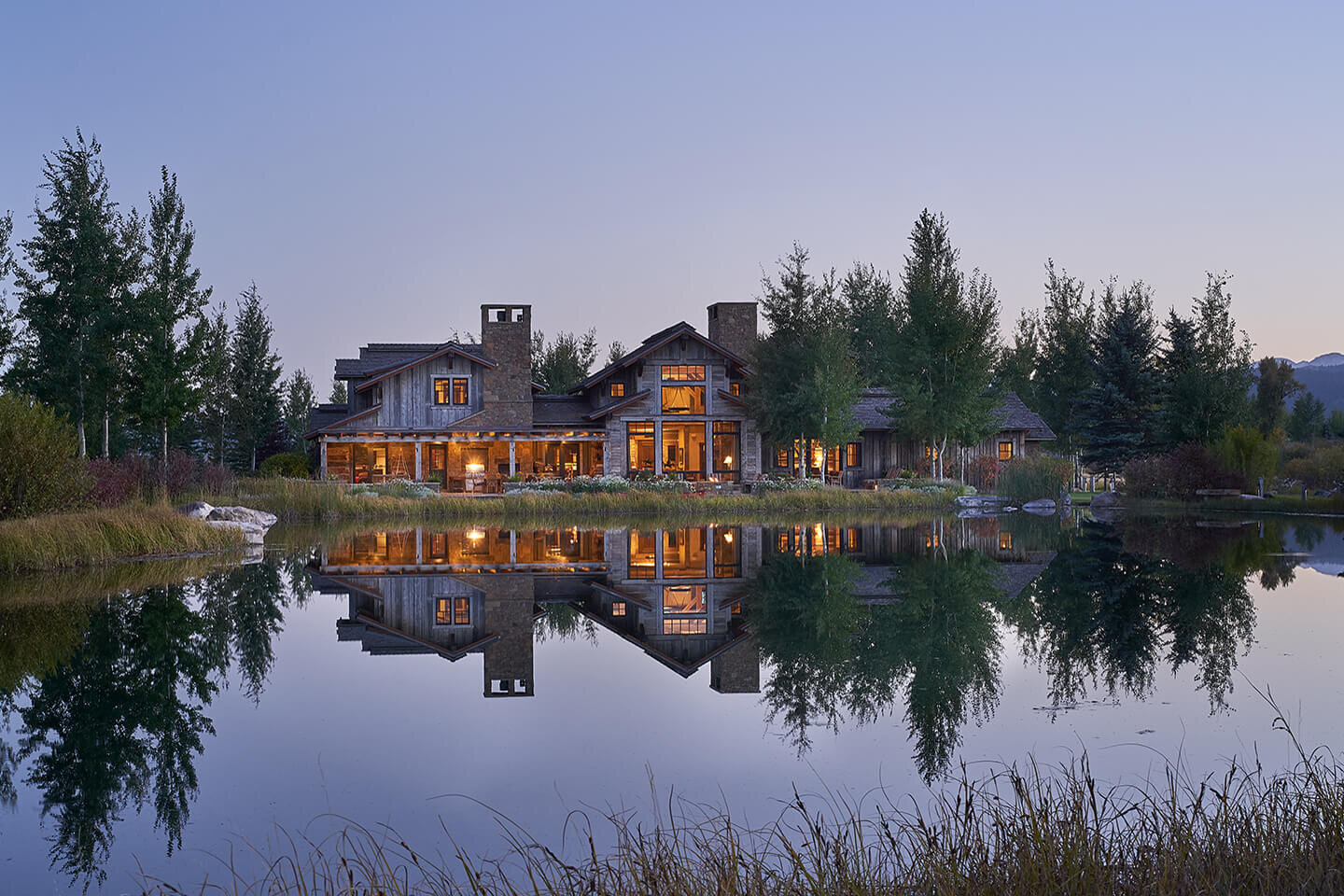 Reflection of residence in pond water at twilight