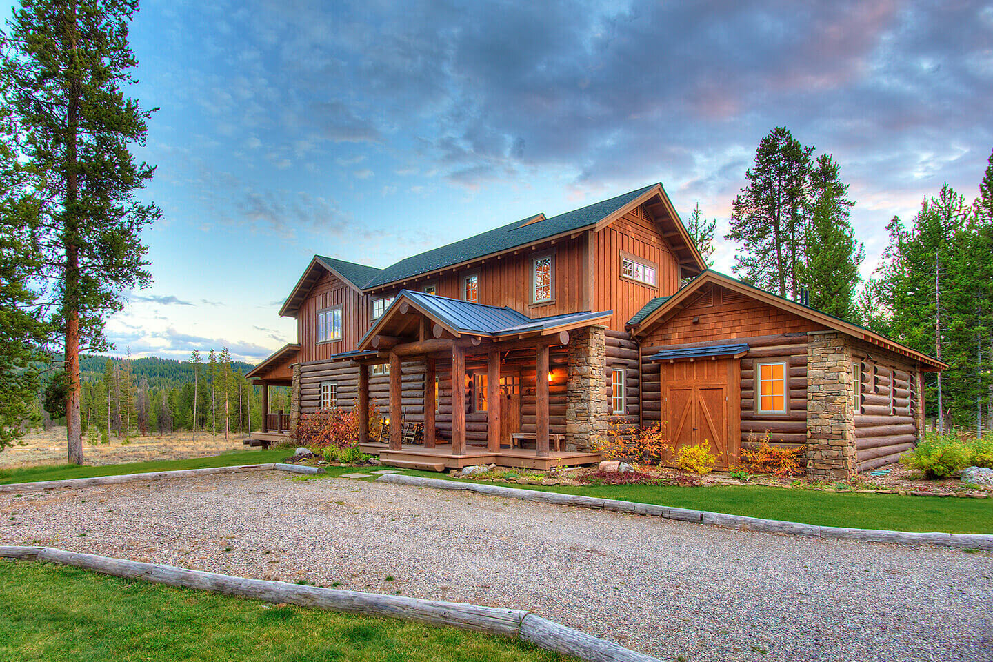 Gravel-lined driveway and log home