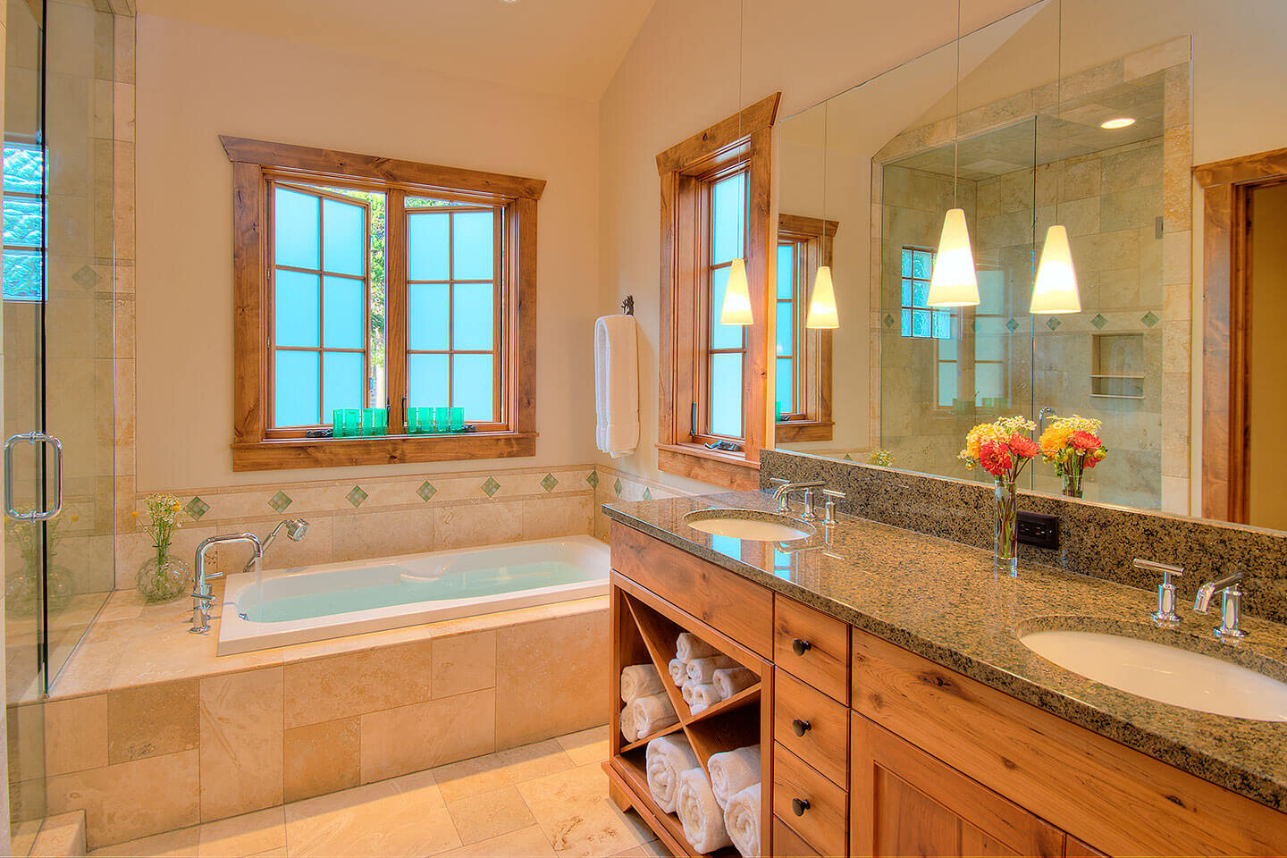 Bathroom with granite counter top and travertine stone