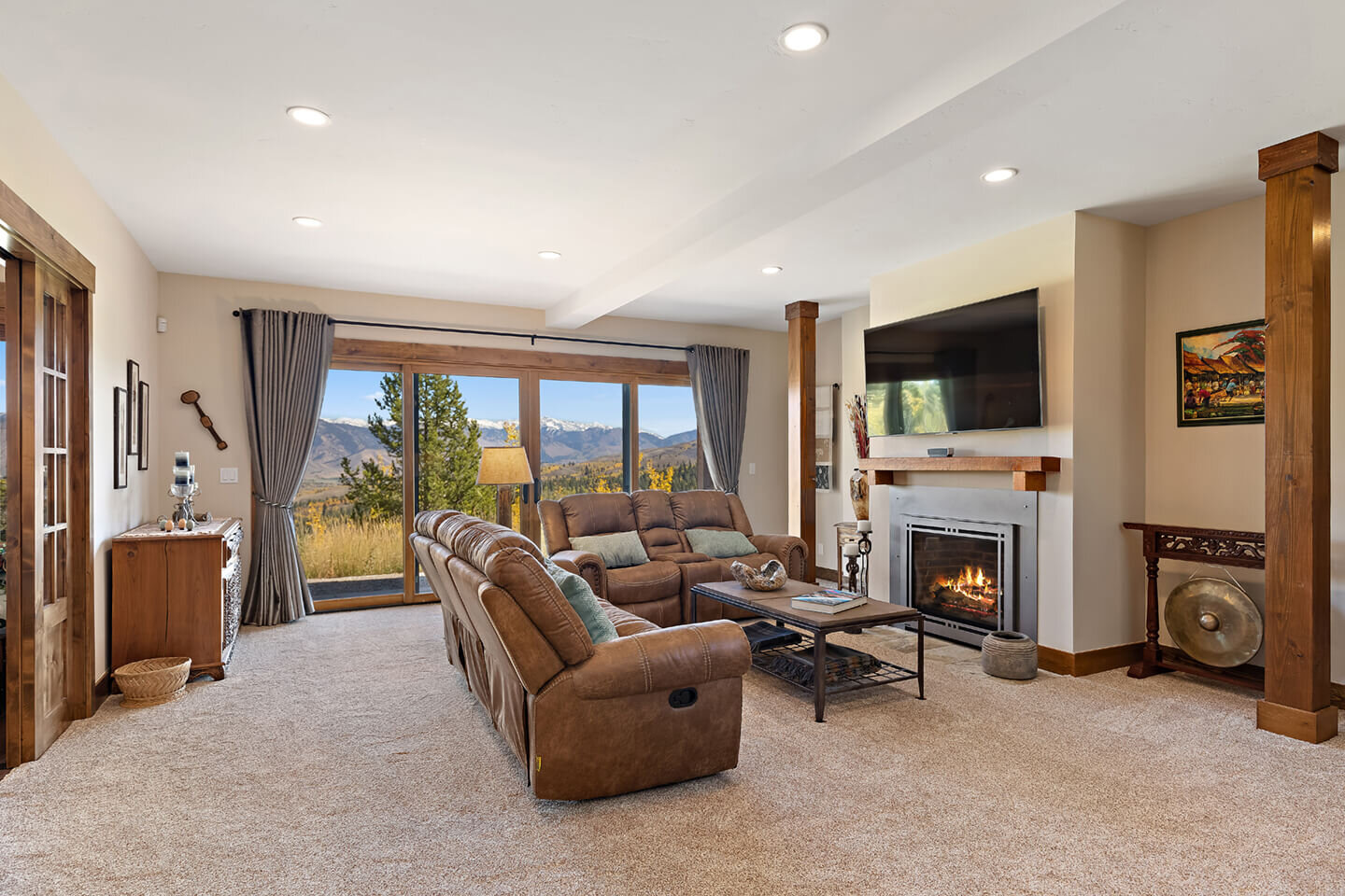 Family room with large windows and fireplace