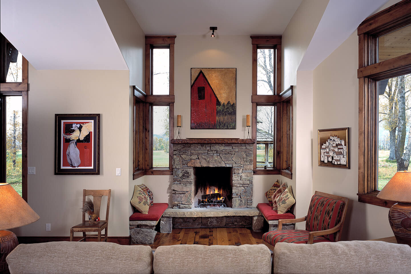 Living room with open hearth fireplace and artwork
