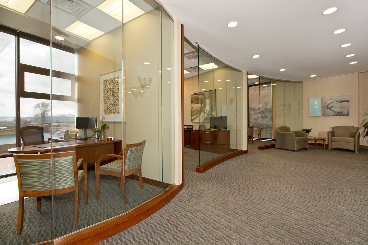 Three offices with curved glass walls
