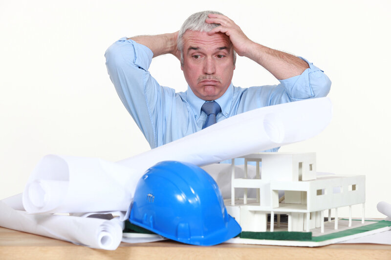 Frustrated architect holding his head