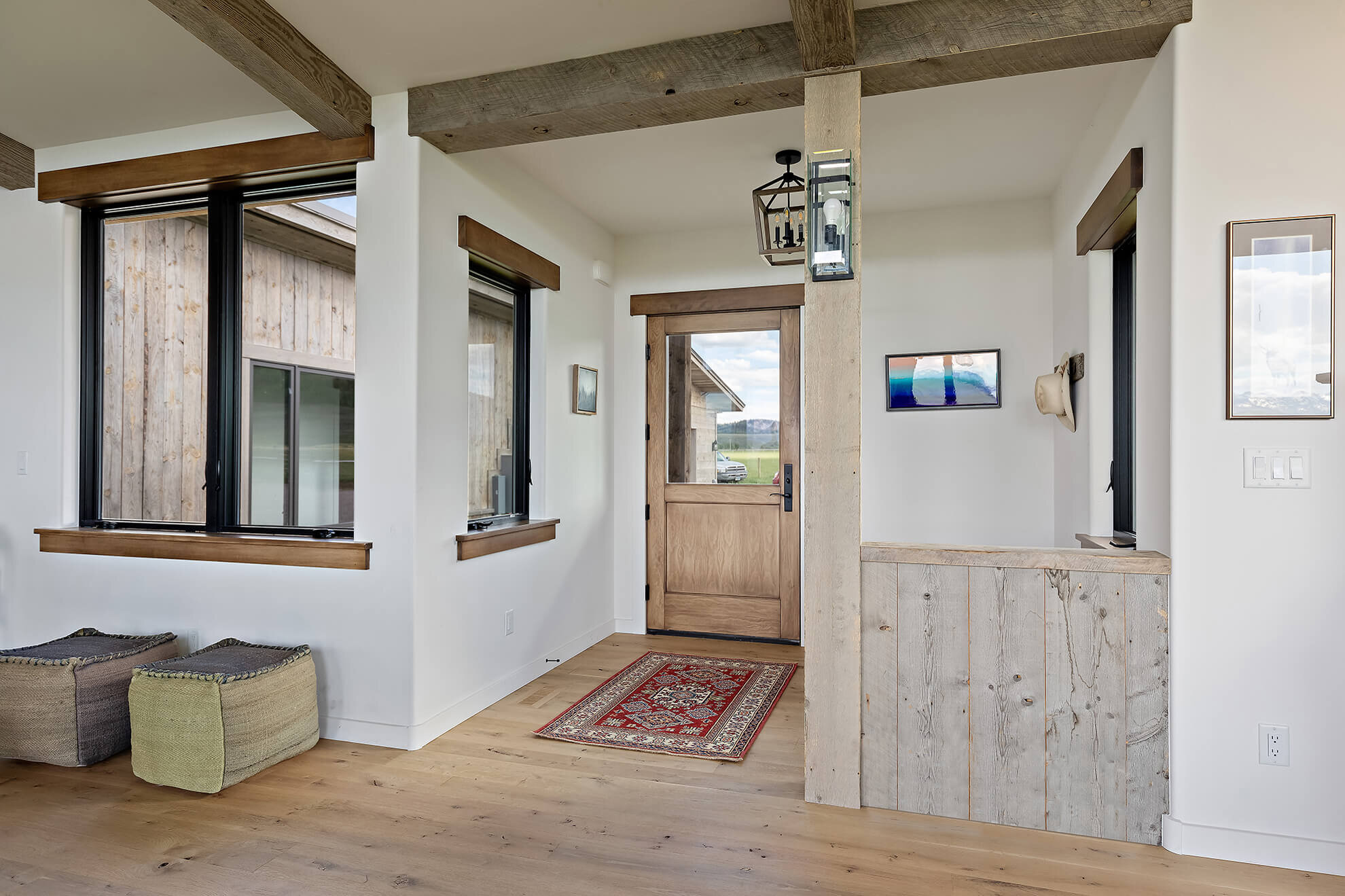 Entryway with white walls and wood beams