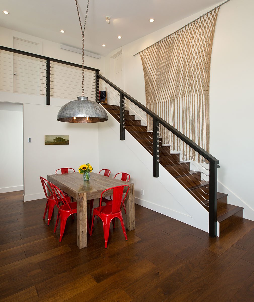 straight staircase with table and red chairs