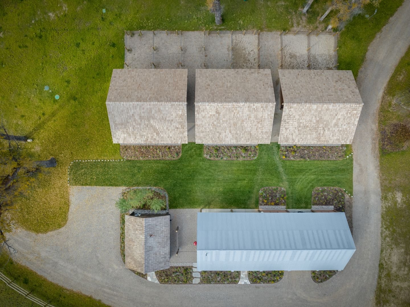 An aerial view showing the relocated pump house, rehabilitated machinery shed and three new stable structures, each with two horse stalls.