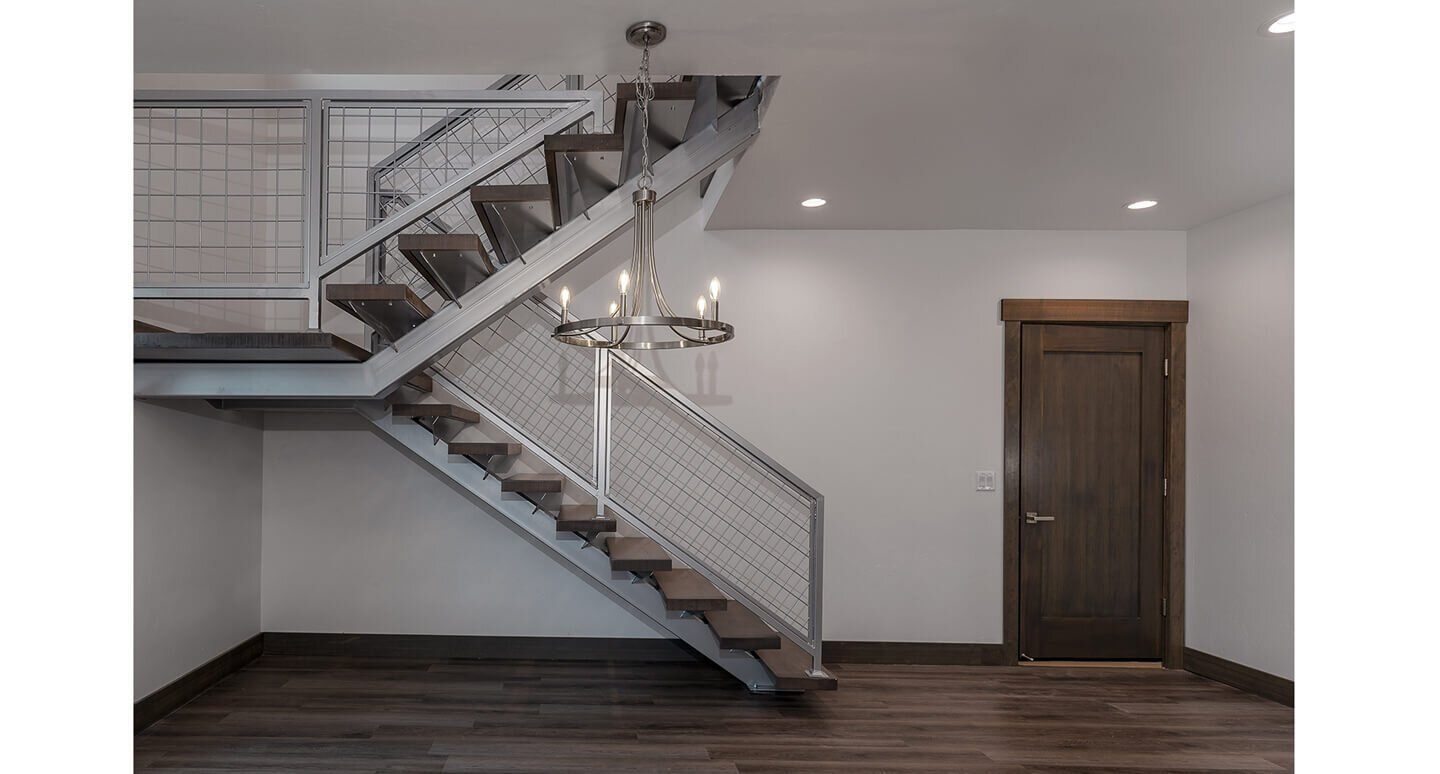 Industrial style staircase and steel chandelier