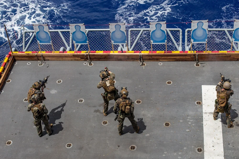 U.S. Marines with Force Reconnaissance Platoon (FRP), 31st Marine Expeditionary Unit (MEU), conduct a live fire deck shoot aboard amphibious assault ship USS America (LHA 6) in the Philippine Sea, Aug. 15, 2021. (U.S. Marine Corps photo by Lance Cpl. Malik Lewis)