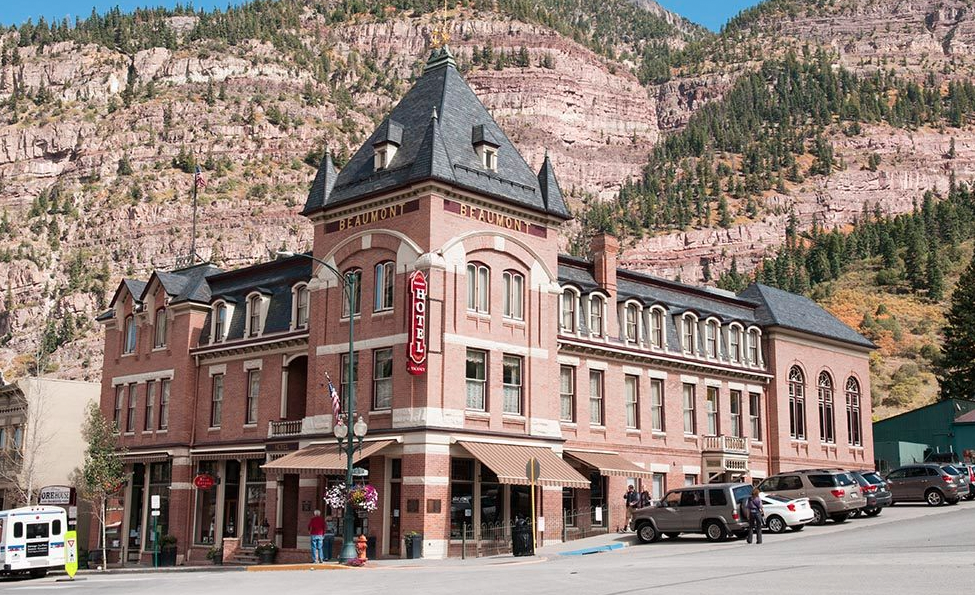 Brick hotel in front of mountains