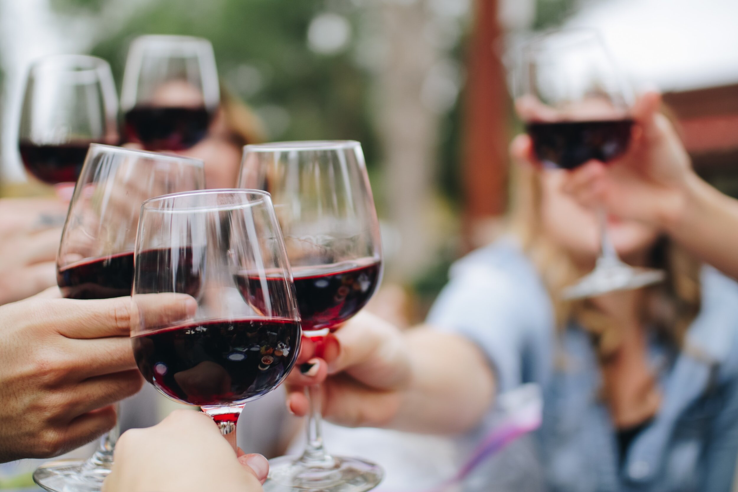 People clinking wine glasses