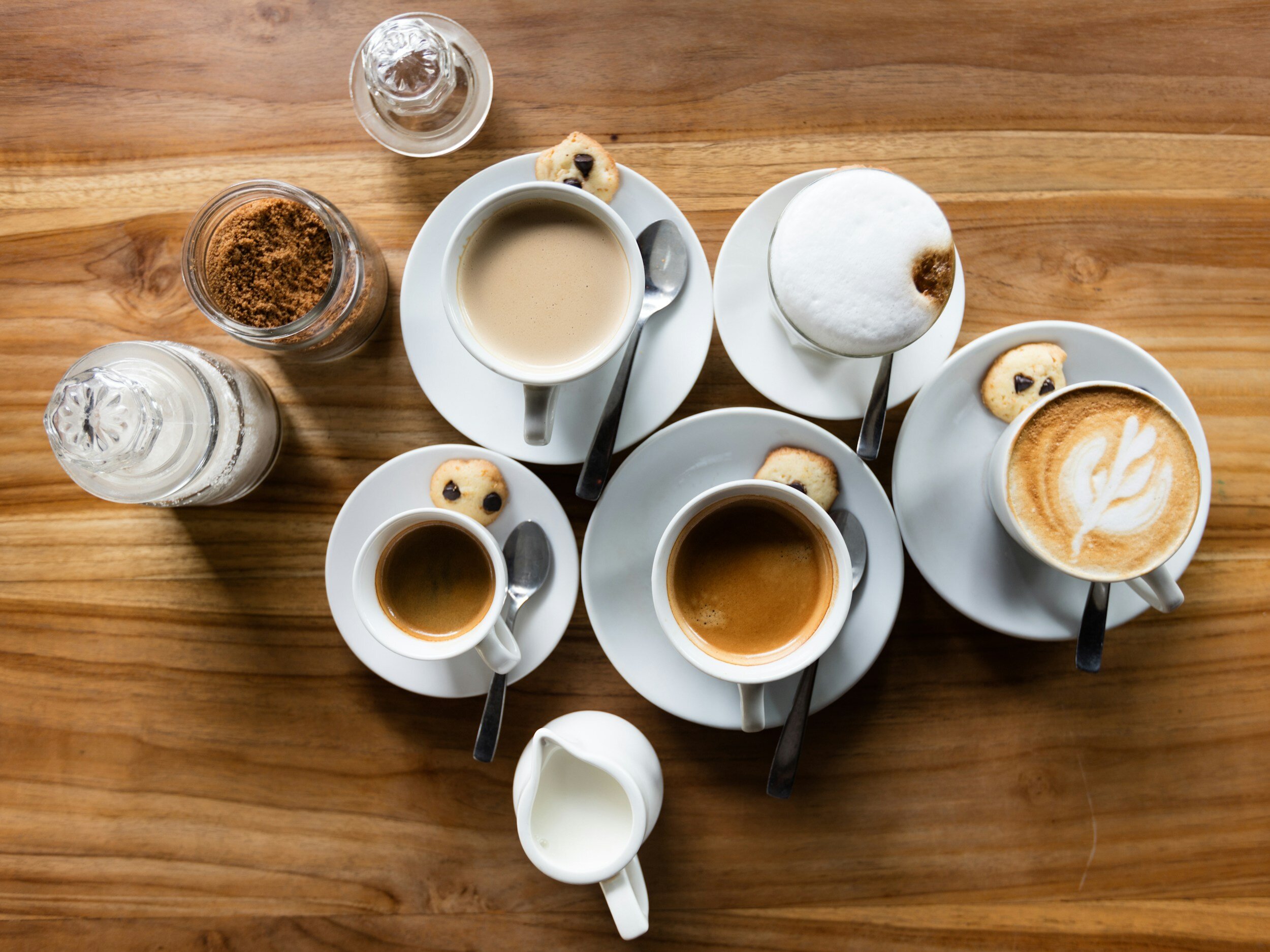 Teacups with coffee on wooden table