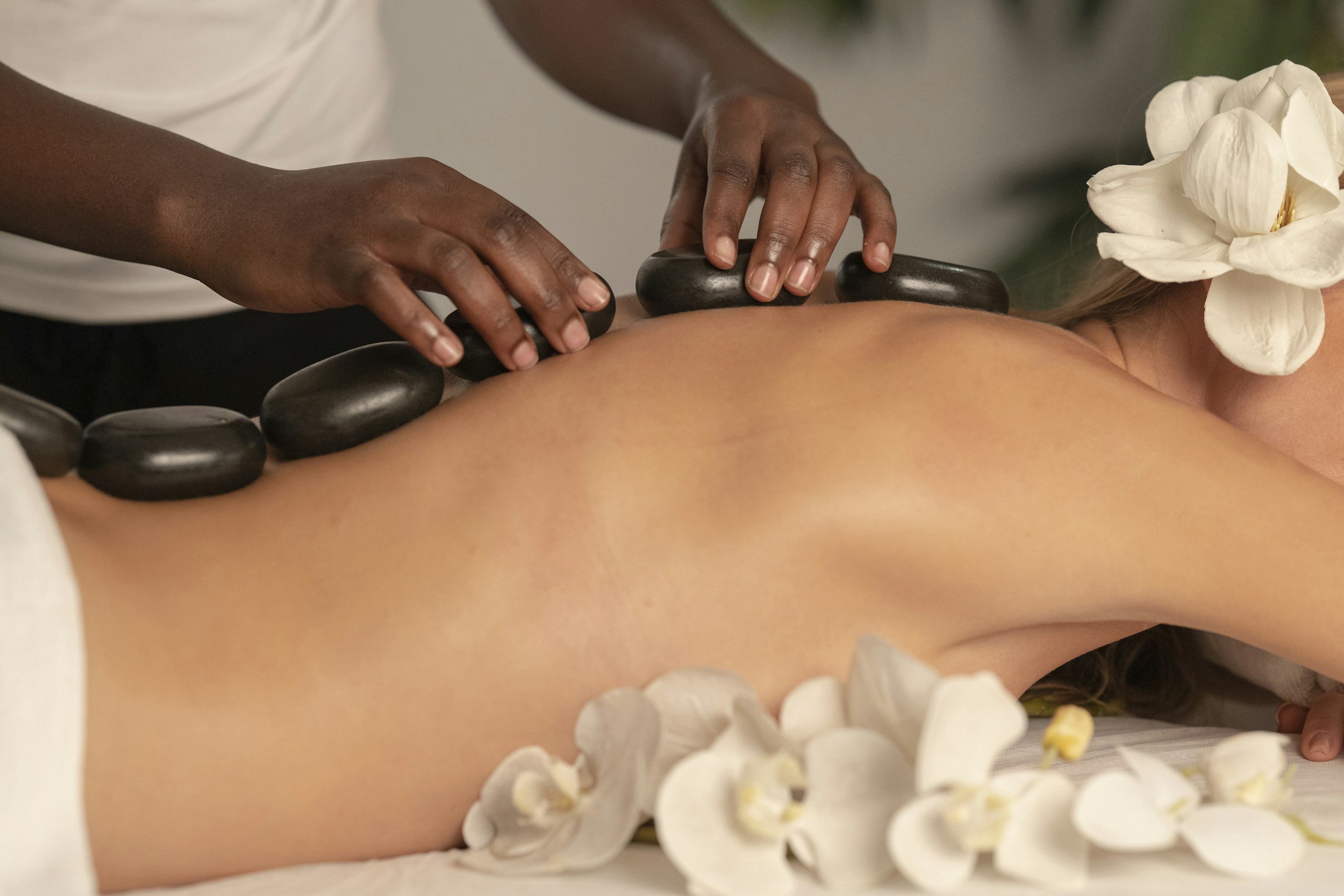 Someone getting massage and hot rocks