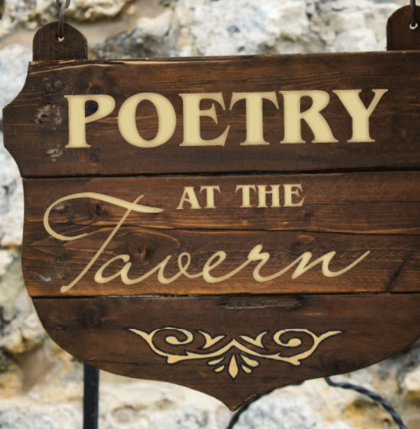 Wood sign reading "poetry at the tavern"