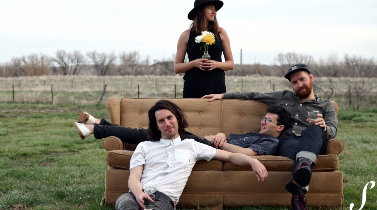 people sitting on couch in field