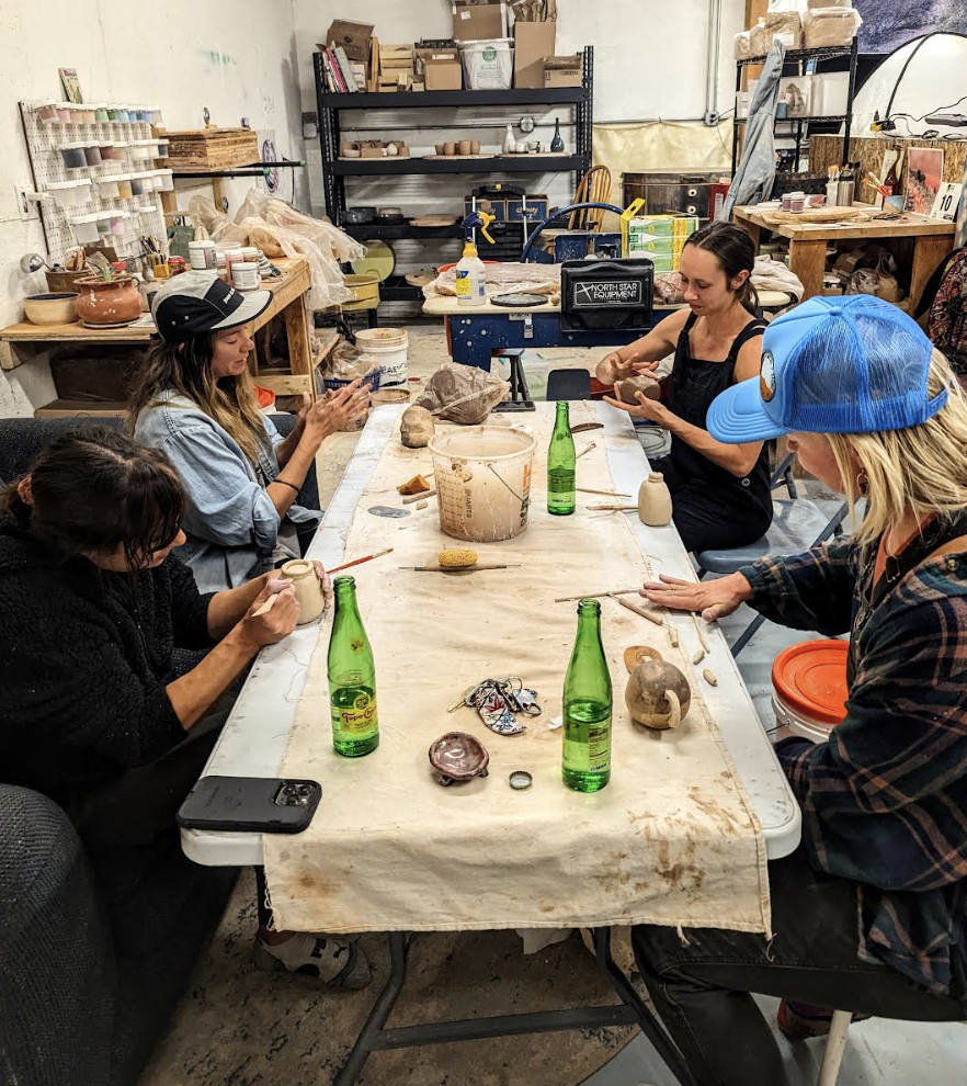 People designing pottery in studio