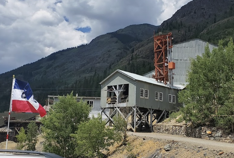Old gold mill sitting at the base of a mountain