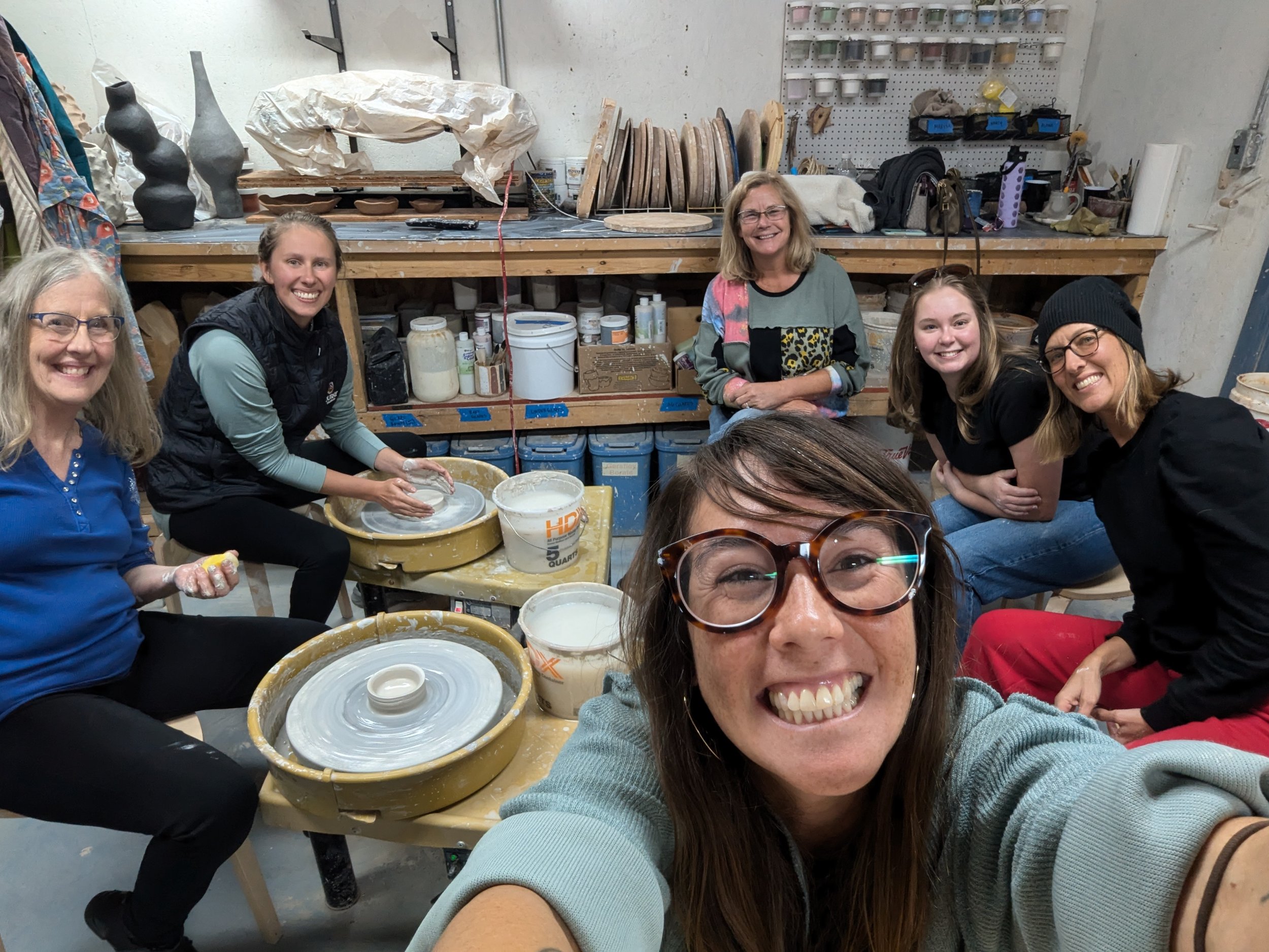 People designing pottery in studio