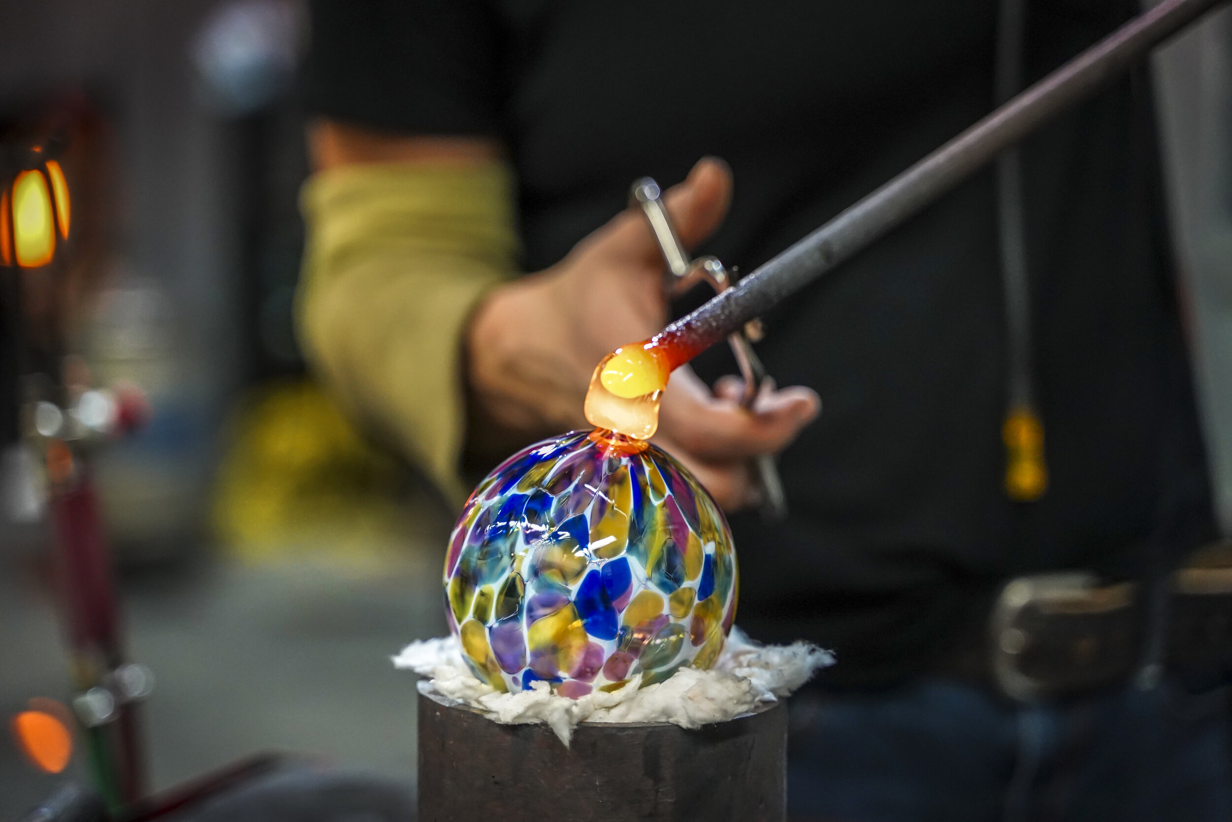 Person Blowing Colorful Glass Ball