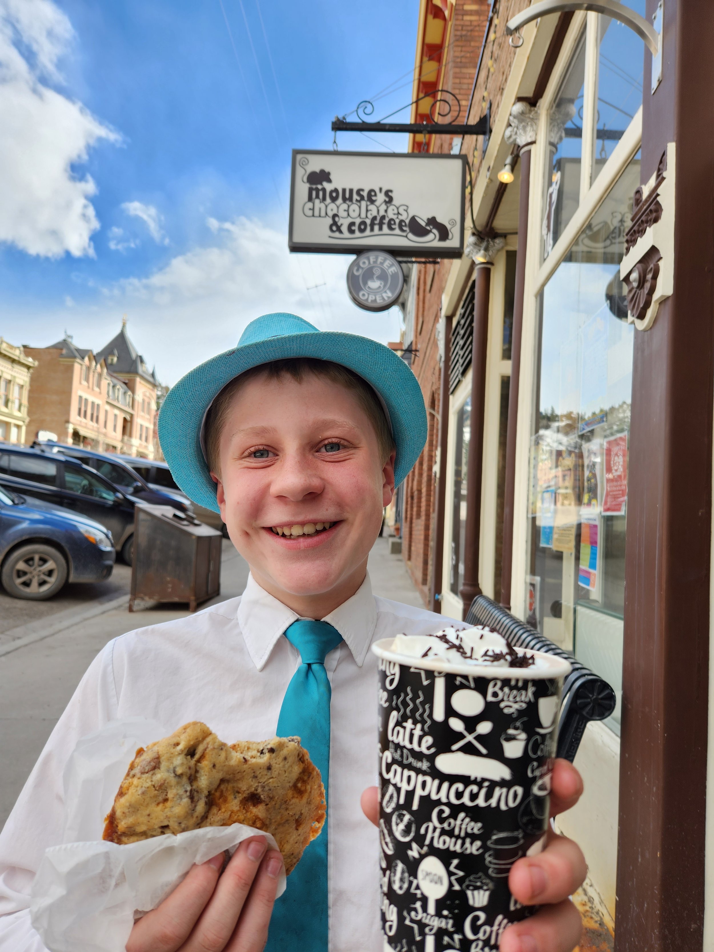 Boy holding ice cream and cookie