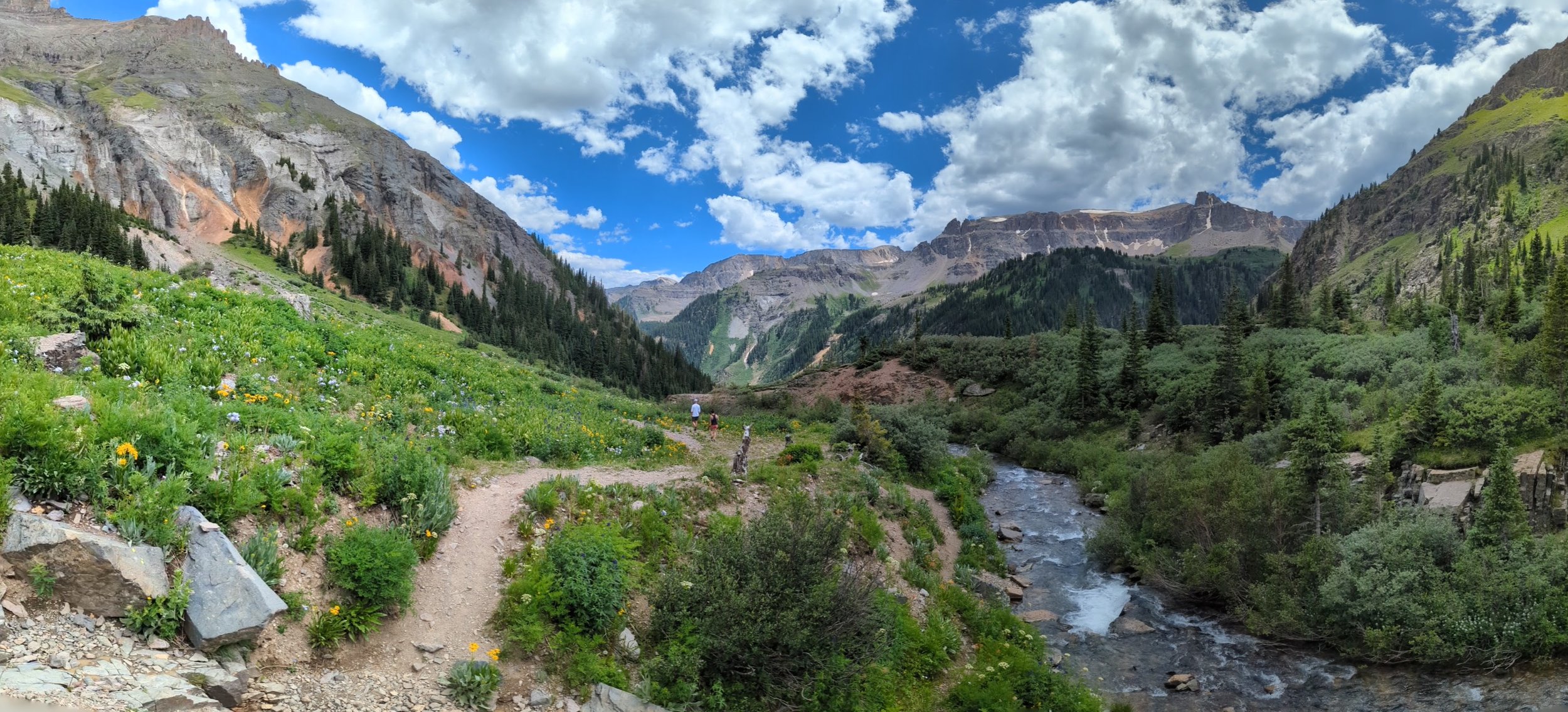 mountain scene with trail and river