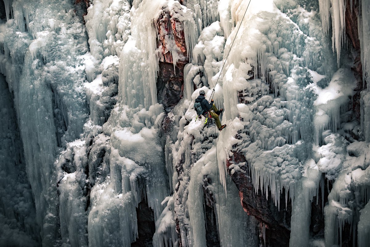 Ice Climber repelling into the canyon