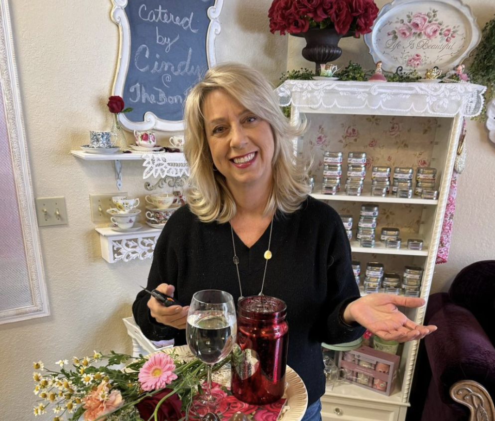 Lady posing with gily, pink flowers in shop